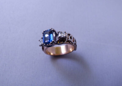 Emerald-cut sapphire and diamond set in palladium and-18ct red ring