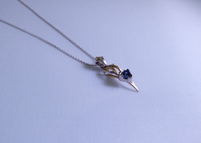 trillion cut tanzanite set in 9ct yellow and palladium pendant